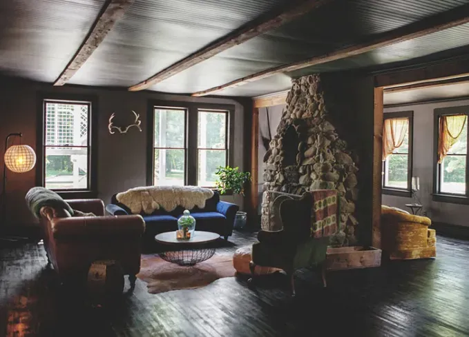 Cozy Winter Weekend Getaways from New York - A dimly-lit living room decorated for winter.' title='The 34 Coziest Winter Weekend Getaways from NYC in 2025