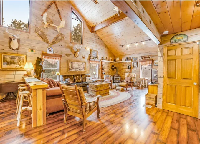 Cozy Winter Weekend Getaways from New York - An all yellow-wood great room is filled with seats at the Bear Lodge. It has incredibly high ceilings and is filled with light.' title='The 34 Coziest Winter Weekend Getaways from NYC in 2025