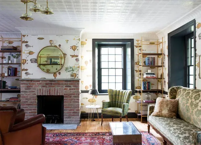 Cozy Winter Weekend Getaways from New York - An eclectically decorated room at the Hasbrouck House with seats and a fireplace.' title='The 34 Coziest Winter Weekend Getaways from NYC in 2025