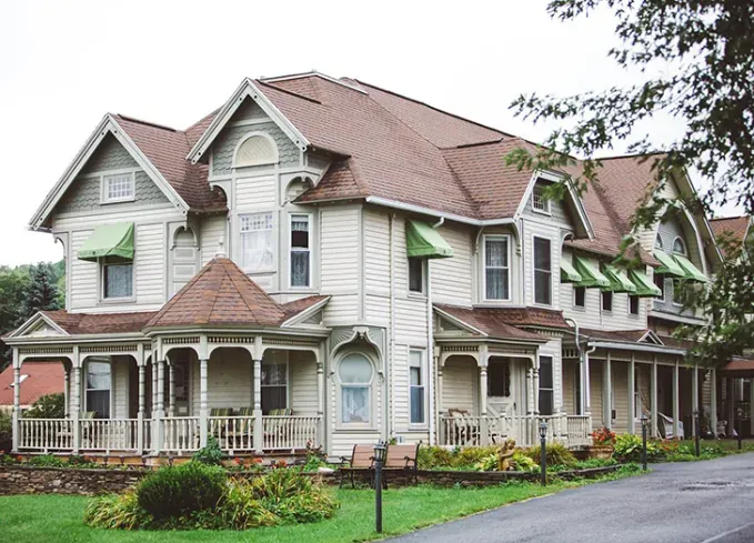 Cozy Winter Weekend Getaways from New York - An ornate white building serves as the Albergo Allegria Hotel & Breakfast Restaurant.' title='The 34 Coziest Winter Weekend Getaways from NYC in 2025