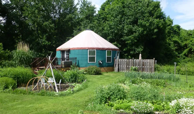Small blue-ish yurt in the middle of a garden.' title='22 Awesome Places to Go Glamping Near New York City