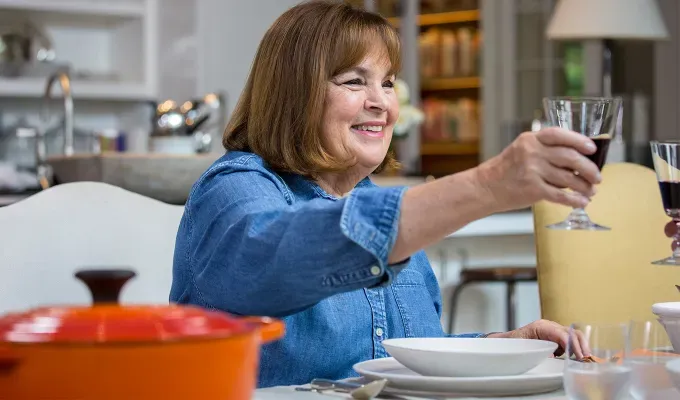 Ina cheers to someone across the table.' fetchpriority='auto' title='Yes That’s a 16-Year-Old Ina Garten in This ’60s Beach Throwback