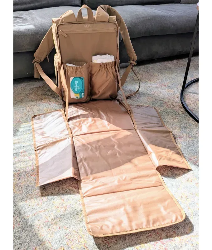 beis diaper backpack unfolded to reveal changing pad' title='If You’re Flying with a Baby This Year You Need to Read This Béis Ultimate Diaper Backpack Review