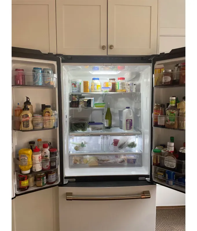 GE-Cafe-Refrigerator: A view of a GE Cafe Refrigerator with both French doors open to reveal its contents.' title='My CAFÈ Refrigerator Review: Stunning Looks & Smart Capabilities