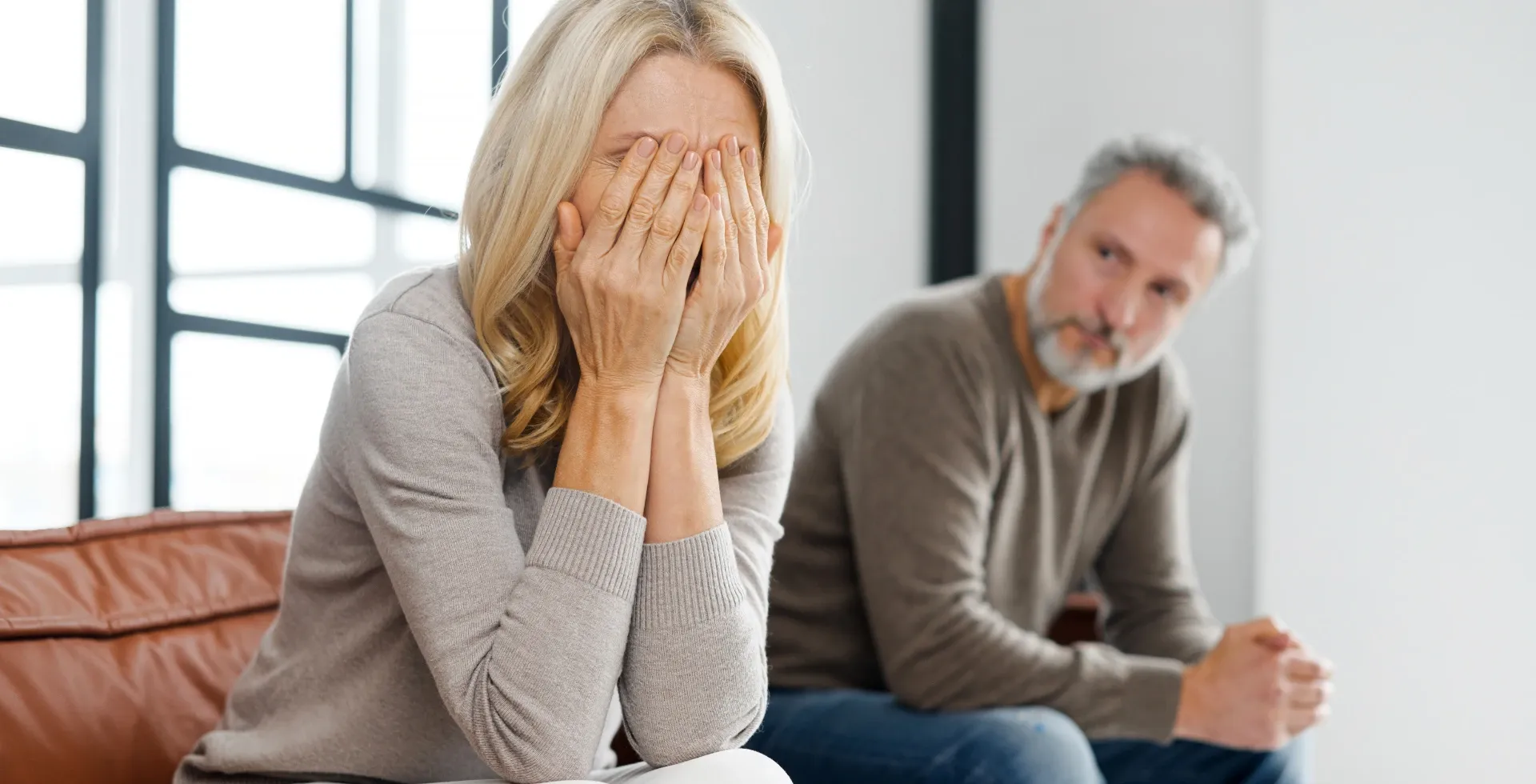 Older woman with her face in her hands on the couch. ' title='Phrases Ungrateful People Say Often According To Psychology' typeof='foaf:Image' decoding='async
