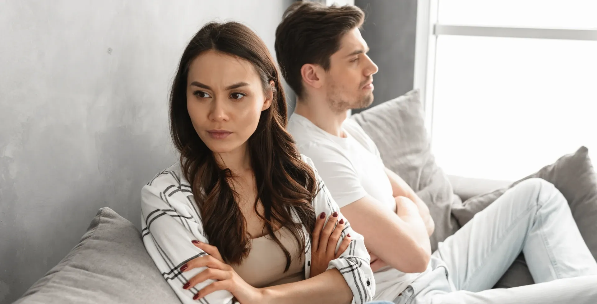 Woman looking away from her partner on the couch.' title='Phrases Ungrateful People Say Often According To Psychology' typeof='foaf:Image' decoding='async
