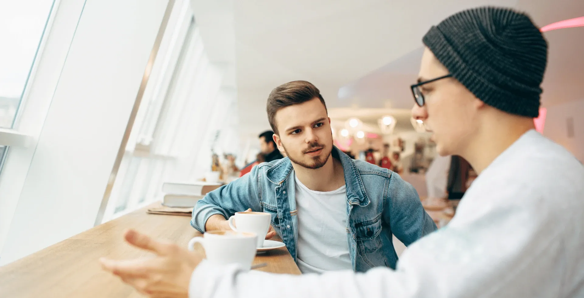 two men talking over coffee' title='Subtle Traits Of People Who Have A Low IQ' typeof='foaf:Image' decoding='async