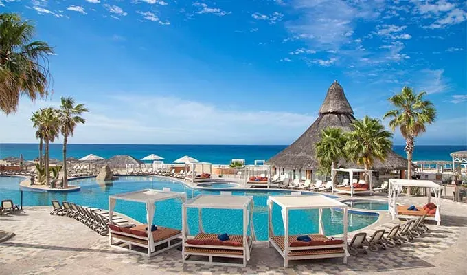 Affordable all-inclusive resorts: Sandos Finisterra poolside palapa restaurant' title='17 Amazing Affordable All-Inclusive Resorts Vetted by a Travel Editor