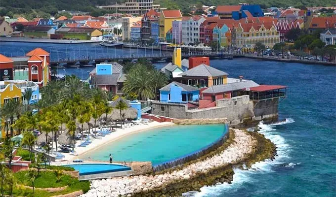 affordable-all-inclusive-resorts: raised beach in front of Curacao resort' title='17 Amazing Affordable All-Inclusive Resorts Vetted by a Travel Editor