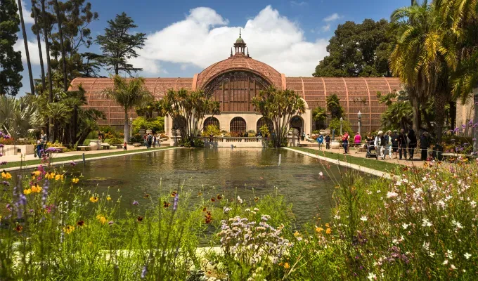 father-son-trip-ideas: The botanical building in Balboa Park in San Diego. There is a large pond pool in front of the building and a number of florals around it.' title='10 Father-Son Trip Ideas for Some Serious Bonding