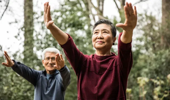 What Might Happen If You Stop Drinking Soda - An older couple does stretches in a wooded area.' fetchpriority='auto' title='8 Things That Might Happen If You Stop Drinking Soda