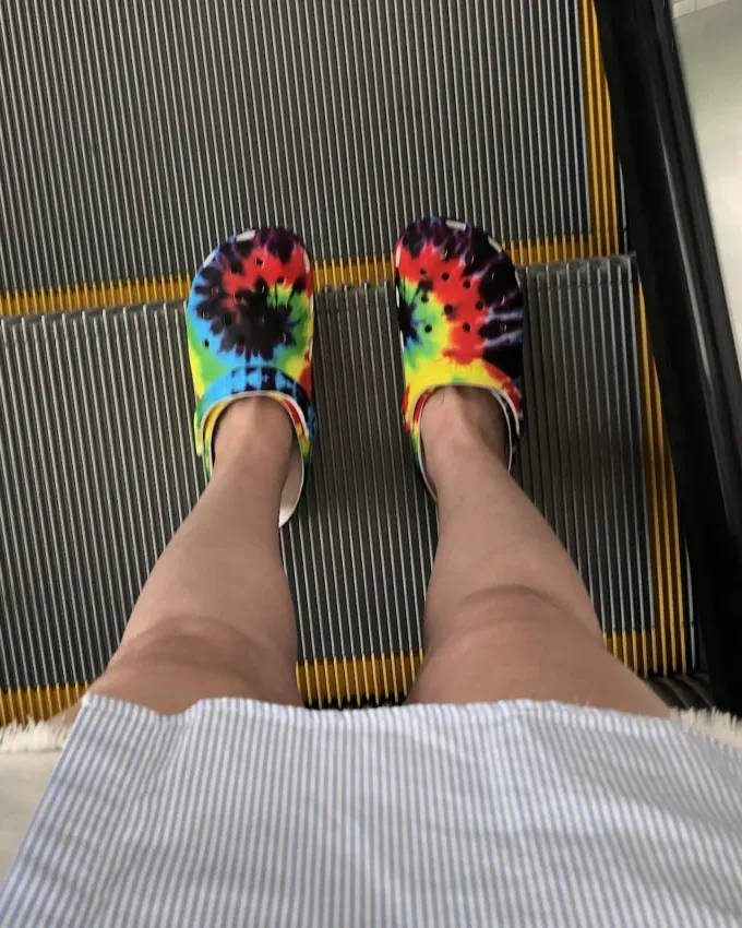 Original photo wearing tie dye Crocs to work on the escalator.' fetchpriority='auto' title='I’m Obsessed With Crocs So I Asked Podiatrists What They Really Think About Them